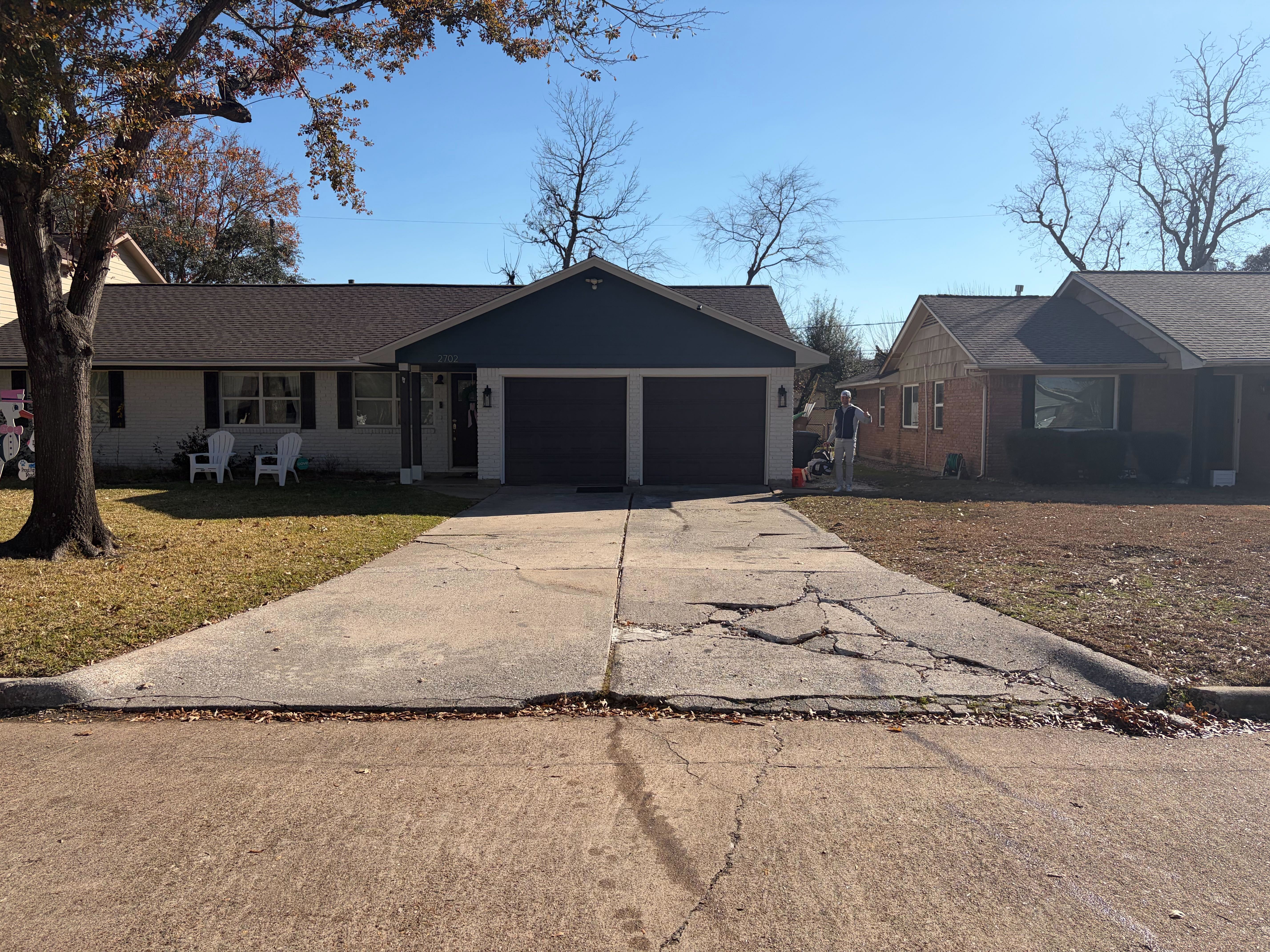 Cracked and damaged concrete driveway in Houston before replacement showing safety hazards and deterioration